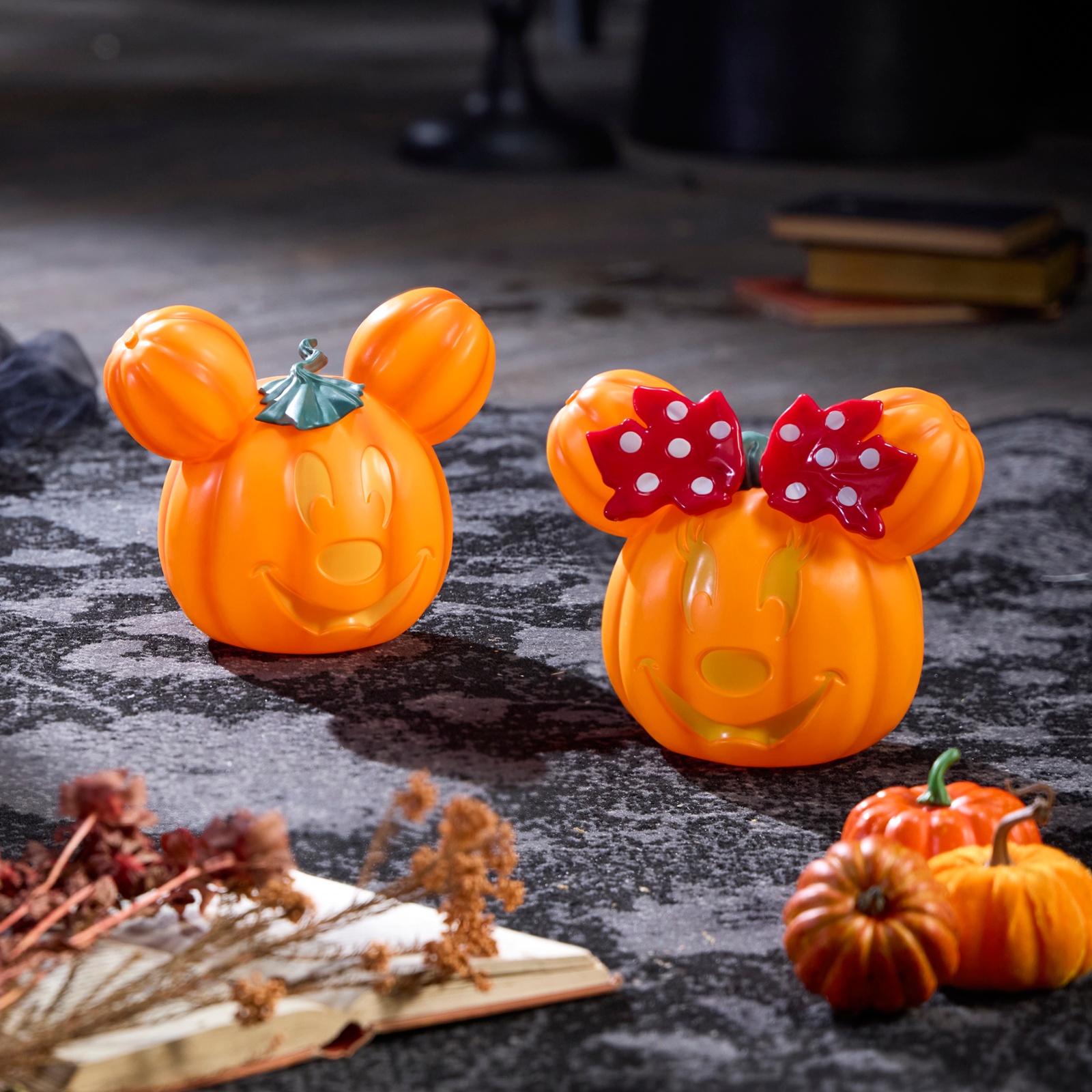 Minnie and Mickey Mouse pumpkin decorations in a Halloween display