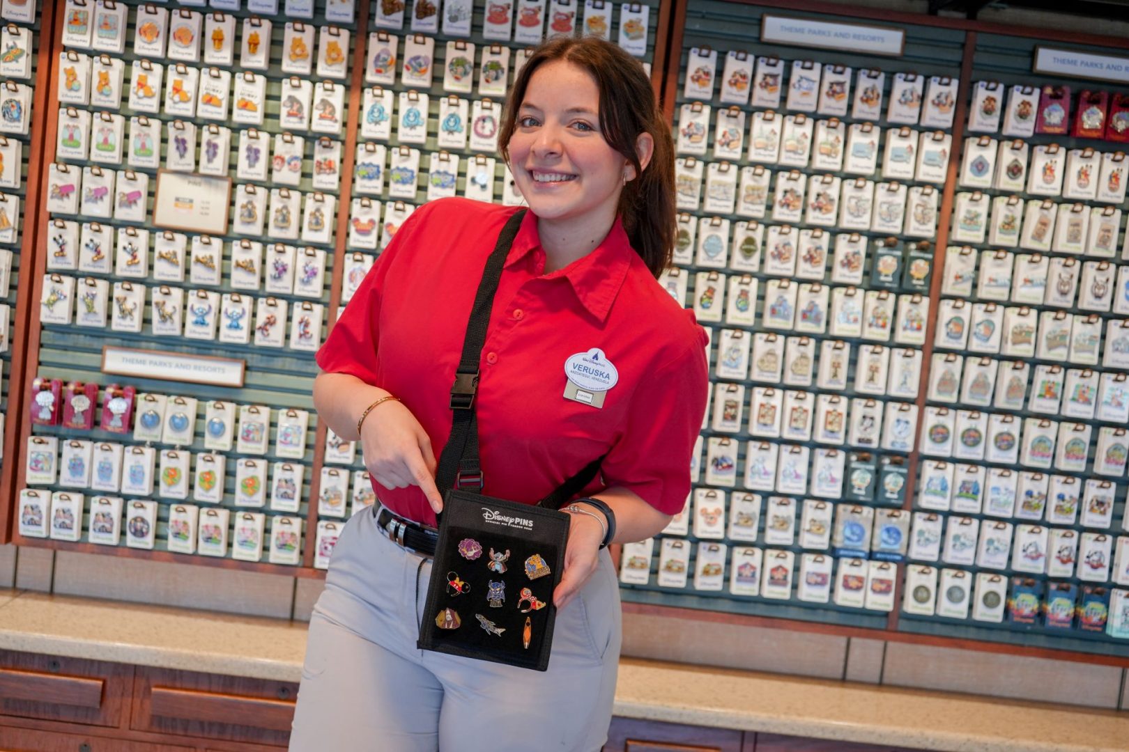 A Walt Disney World Cast Member wearing a pin-trading pack