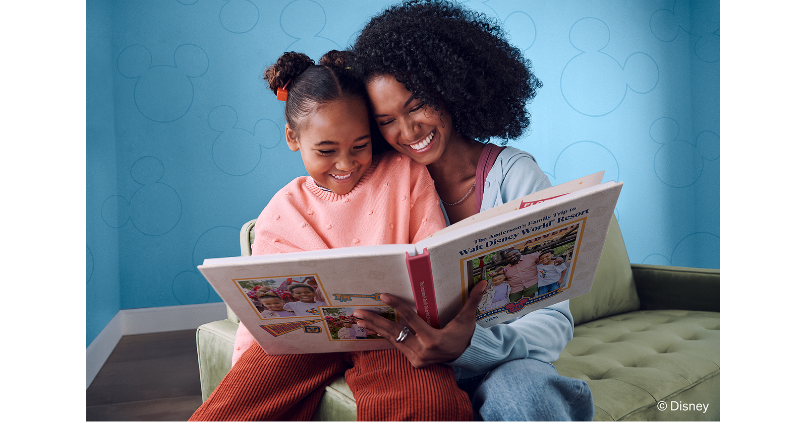 A mother and child look through a Walt Disney World photo book made with family vacation pictures