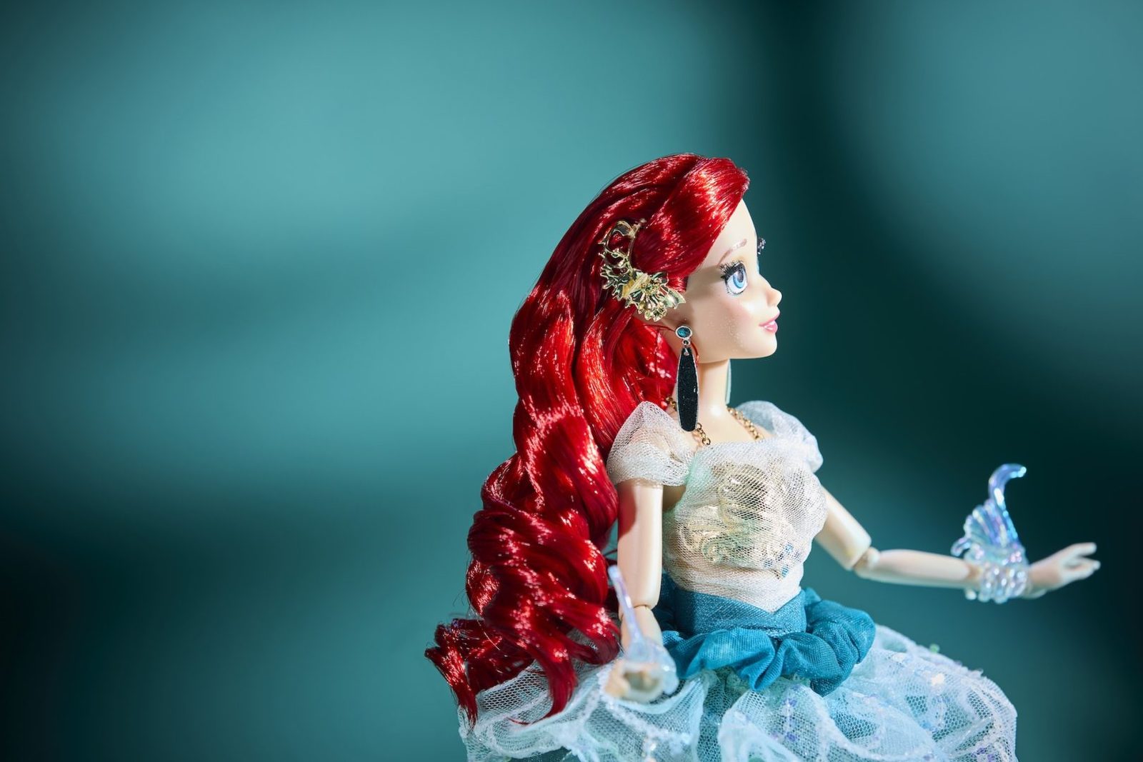 Ariel Designer Doll shown in profile with curled red hair