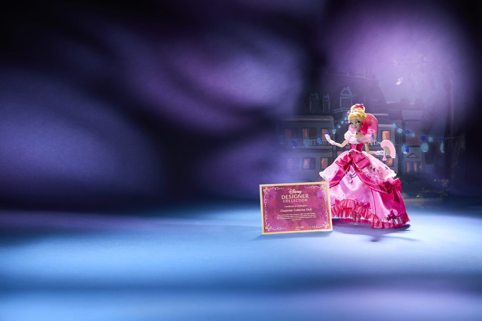 Charlotte Lottie La Bouff Designer Doll posed beneath a spotlight beside a display card