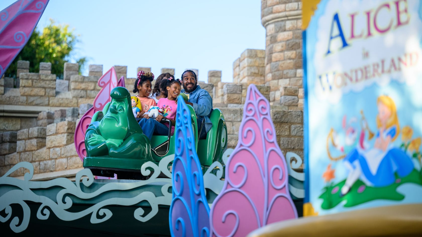 A family riding Alice in Wonderland at Disneyland