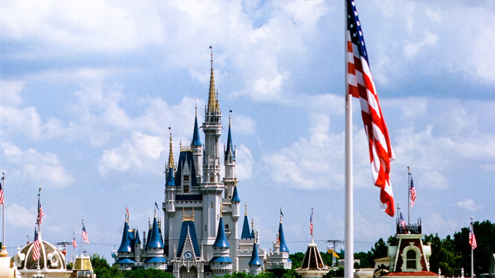 The American flag flying near Cinderella Castle at Magic Kingdom