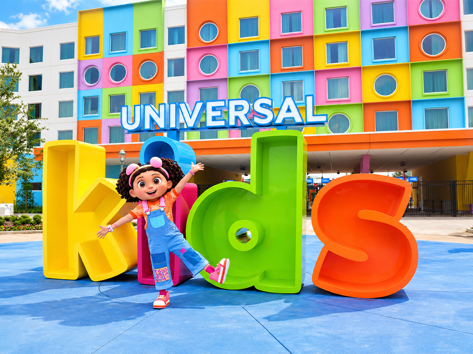 Gabby stands in front of the Universal Kids Resort hotel and oversized Kids letters