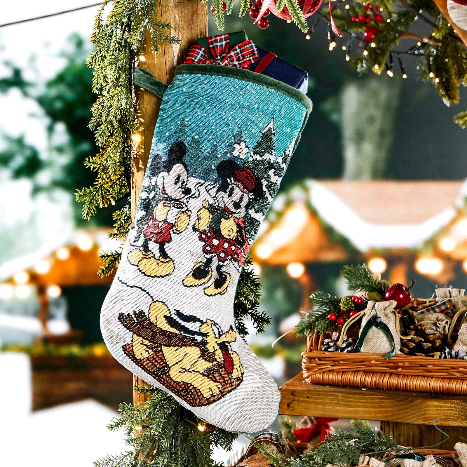 Mickey Mouse and Friends Christmas stocking hanging beside a tree