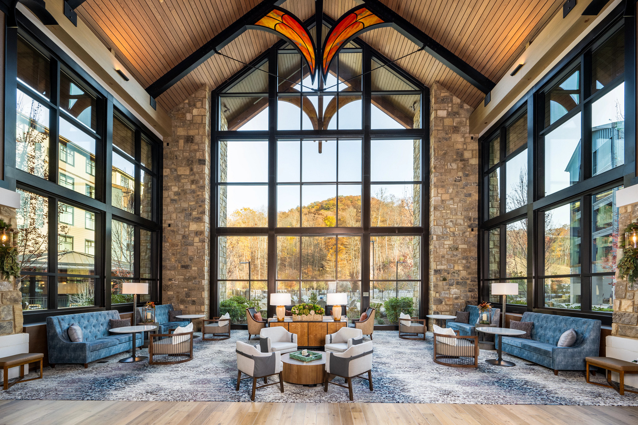The lounge at Dollywood’s HeartSong Lodge & Resort with floor-to-ceiling windows overlooking the Smoky Mountains