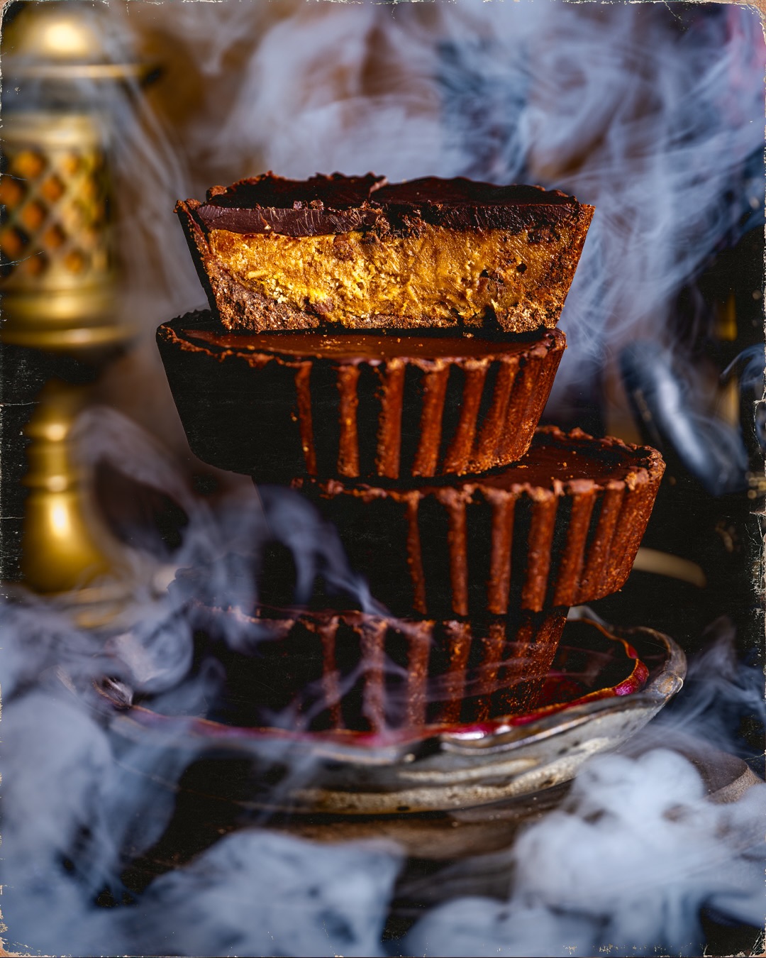A stack of Gideon’s Monstrous Peanut Butter Cup Tarts, with one cut open to show the filling