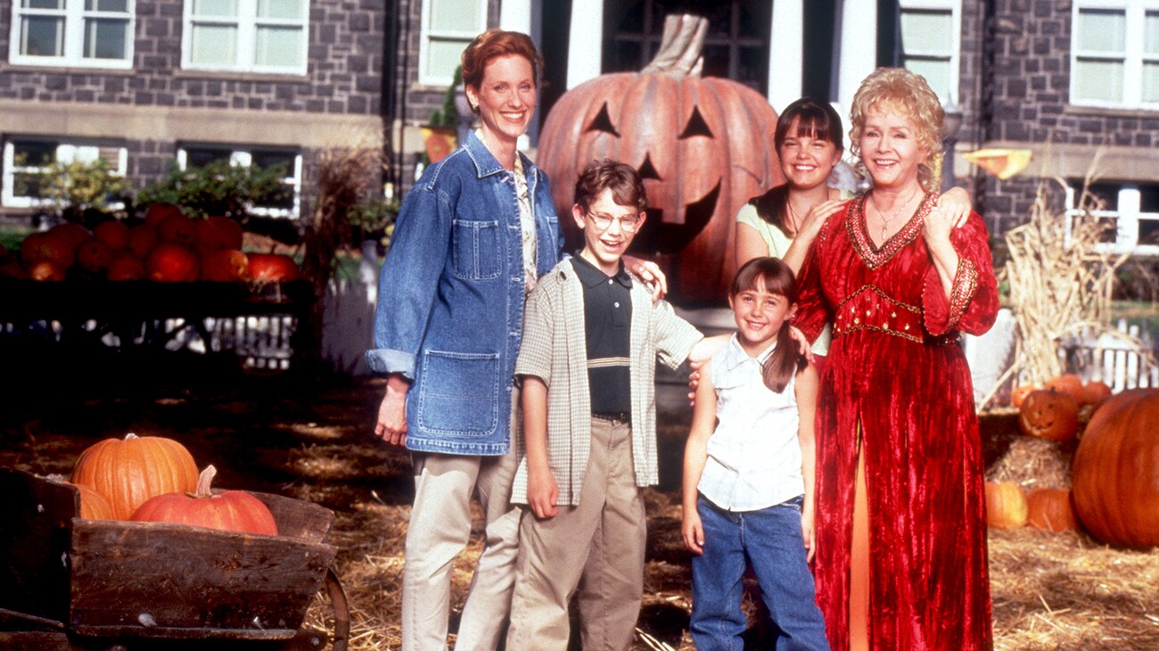 Debbie Reynolds, Kimberly J. Brown, Judith Hoag, Emily Roeske and Joey Zimmerman stand in a pumpkin patch in Halloweentown