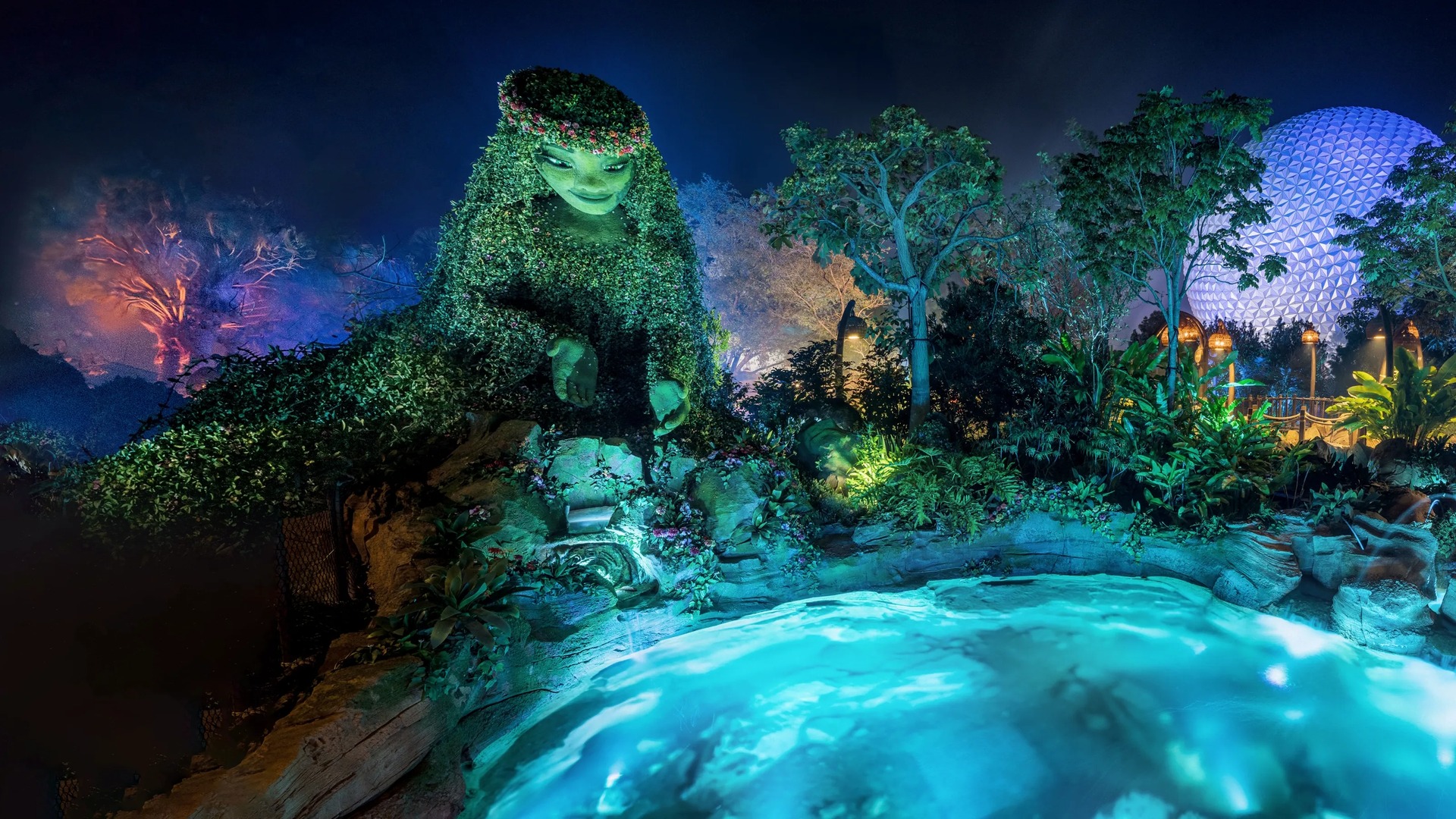 Journey of Water, Inspired by Moana illuminated at night with Spaceship Earth in the background