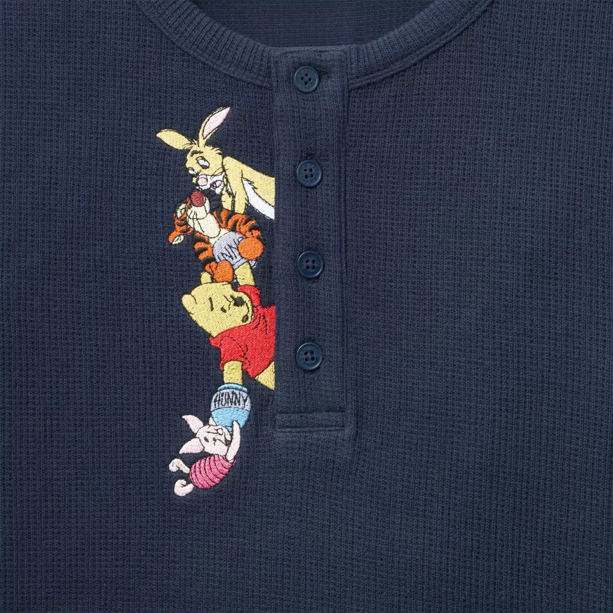 Close view of Rabbit, Tigger, Pooh and Piglet embroidered beside the buttons