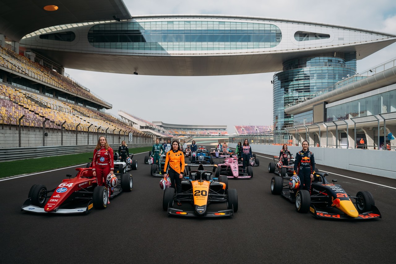 F1 ACADEMY drivers stand with their race cars at the Shanghai International Circuit