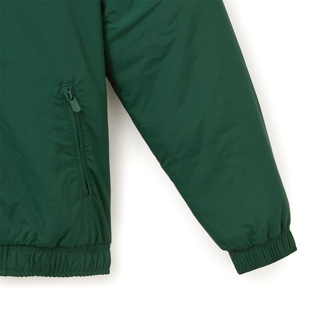 Close view of the jacket’s zippered pocket and elastic cuff