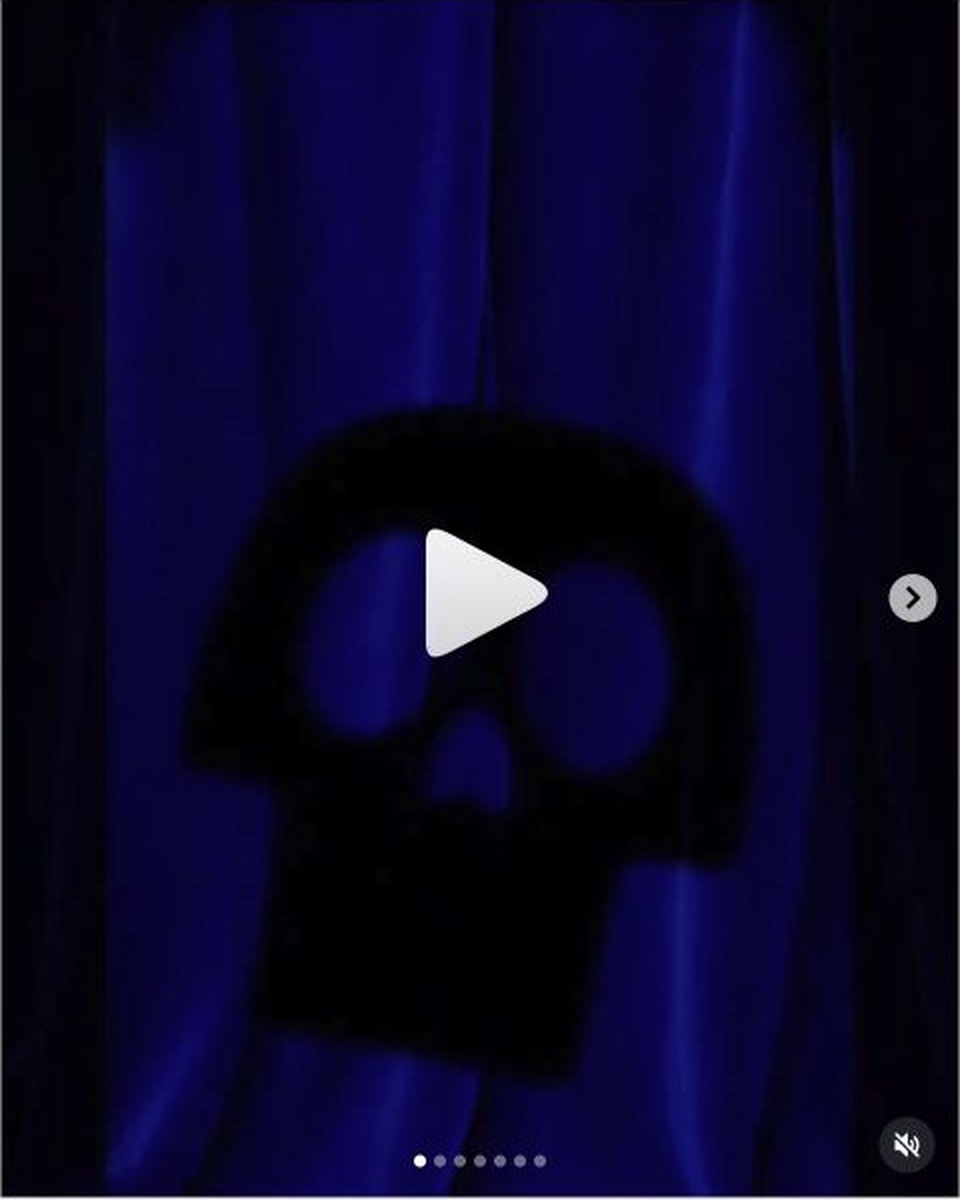 A dark skull-shaped silhouette appears against blue-purple curtains in Shanghai Disney Resort’s Halloween treats teaser