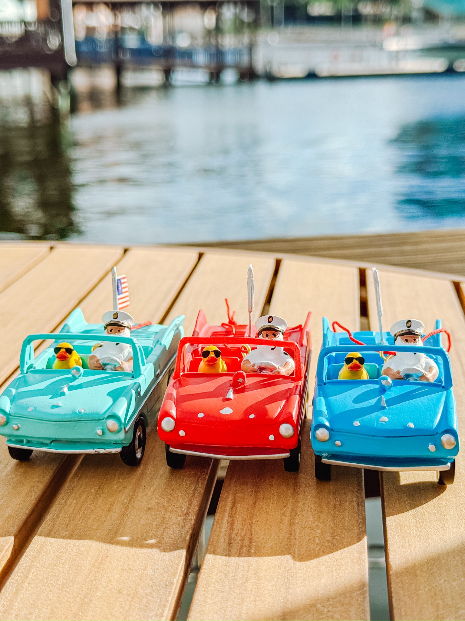 Red, turquoise and blue Amphicar Christmas ornaments with captains and yellow ducks