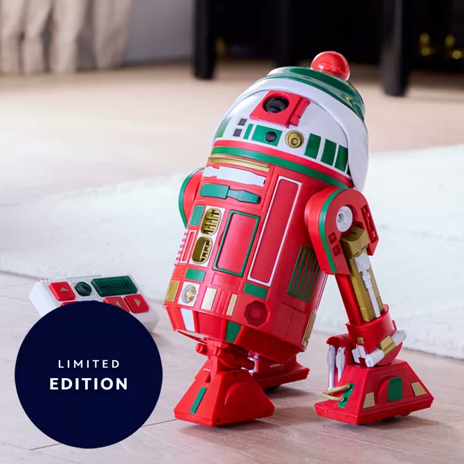 R2-H16 holiday droid in red, green and white beside its remote control