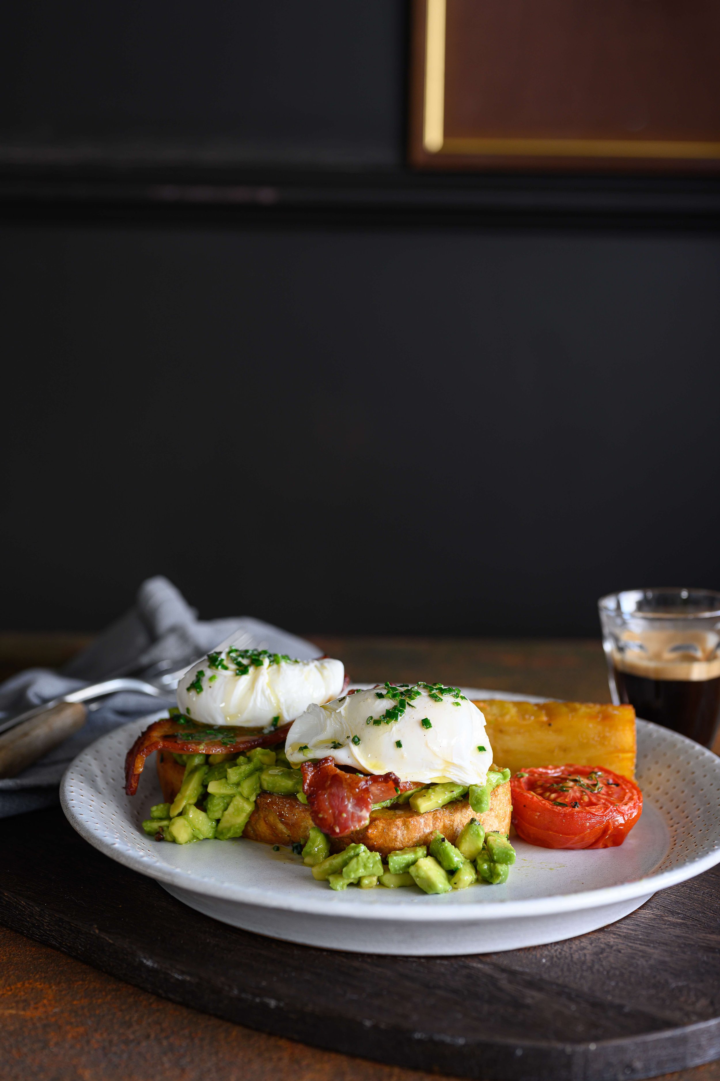 Poached eggs, avocado, bacon, tomato and potatoes served at Raglan Road