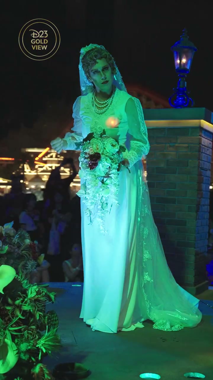A ghostly bride holding a bouquet in Madame Leota’s Swinging Wake