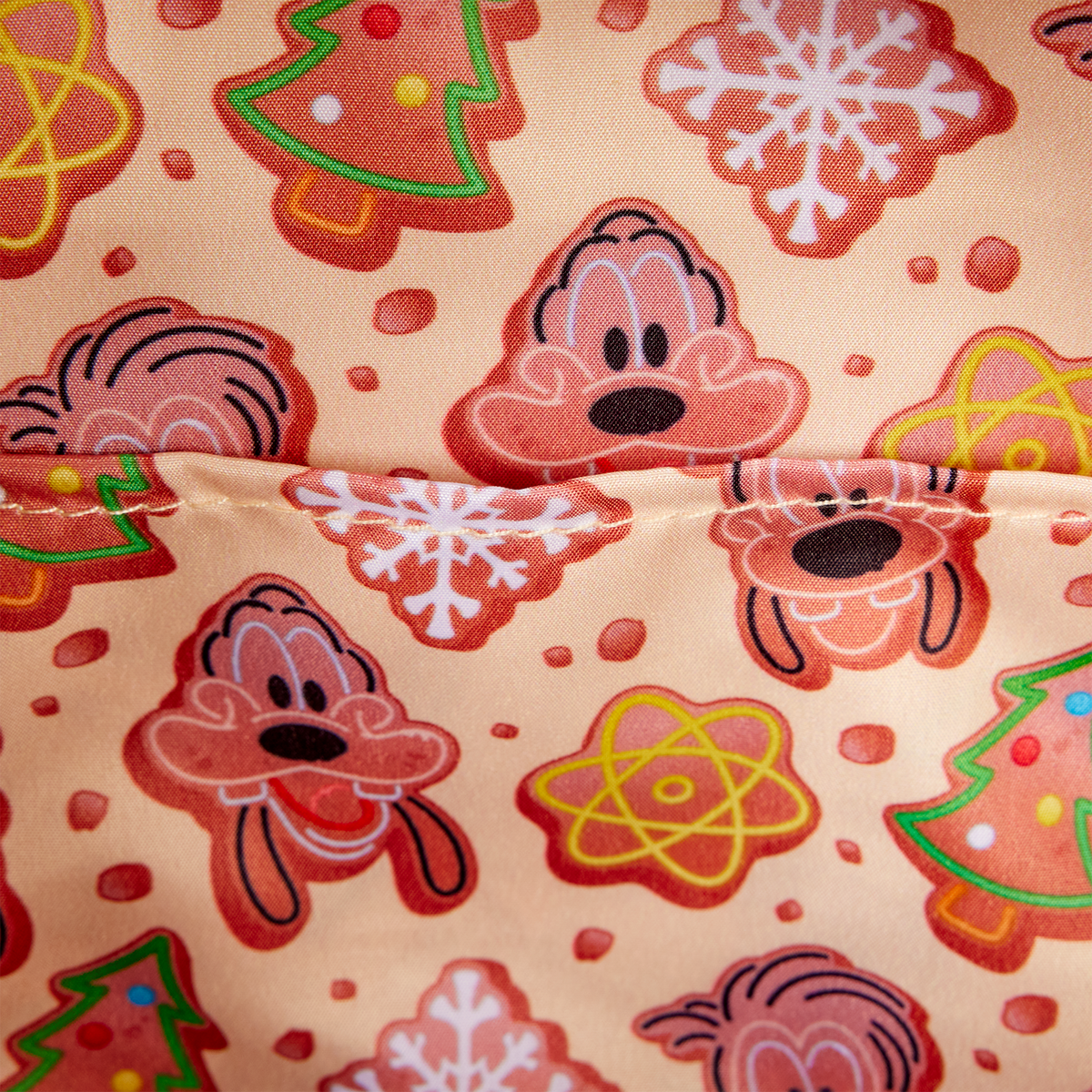 Interior lining of the Goofy and Max holiday Loungefly backpack with cookies, trees and snowflakes