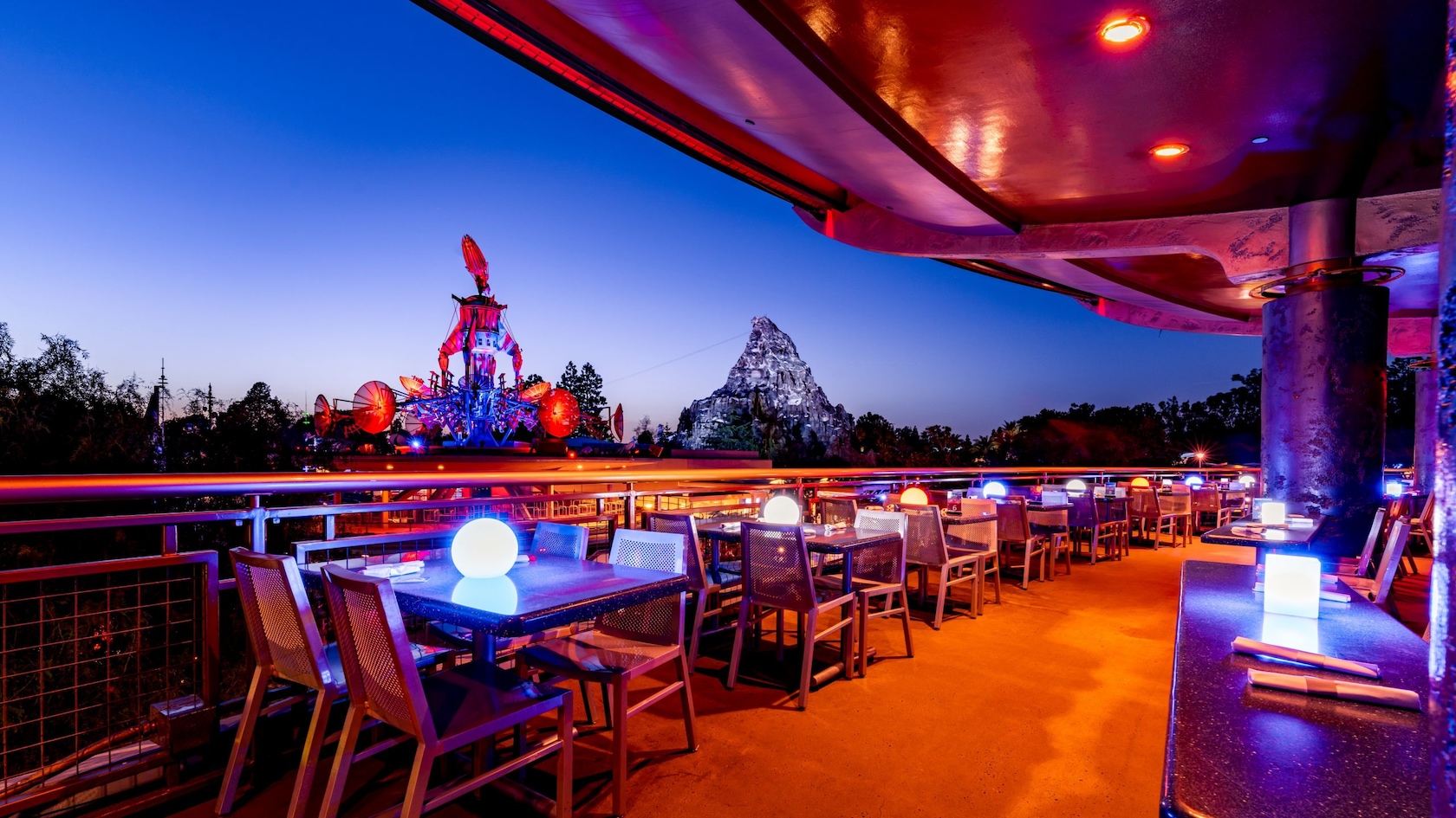 Tomorrowland Skyline Terrace tables overlook Disneyland Park at twilight