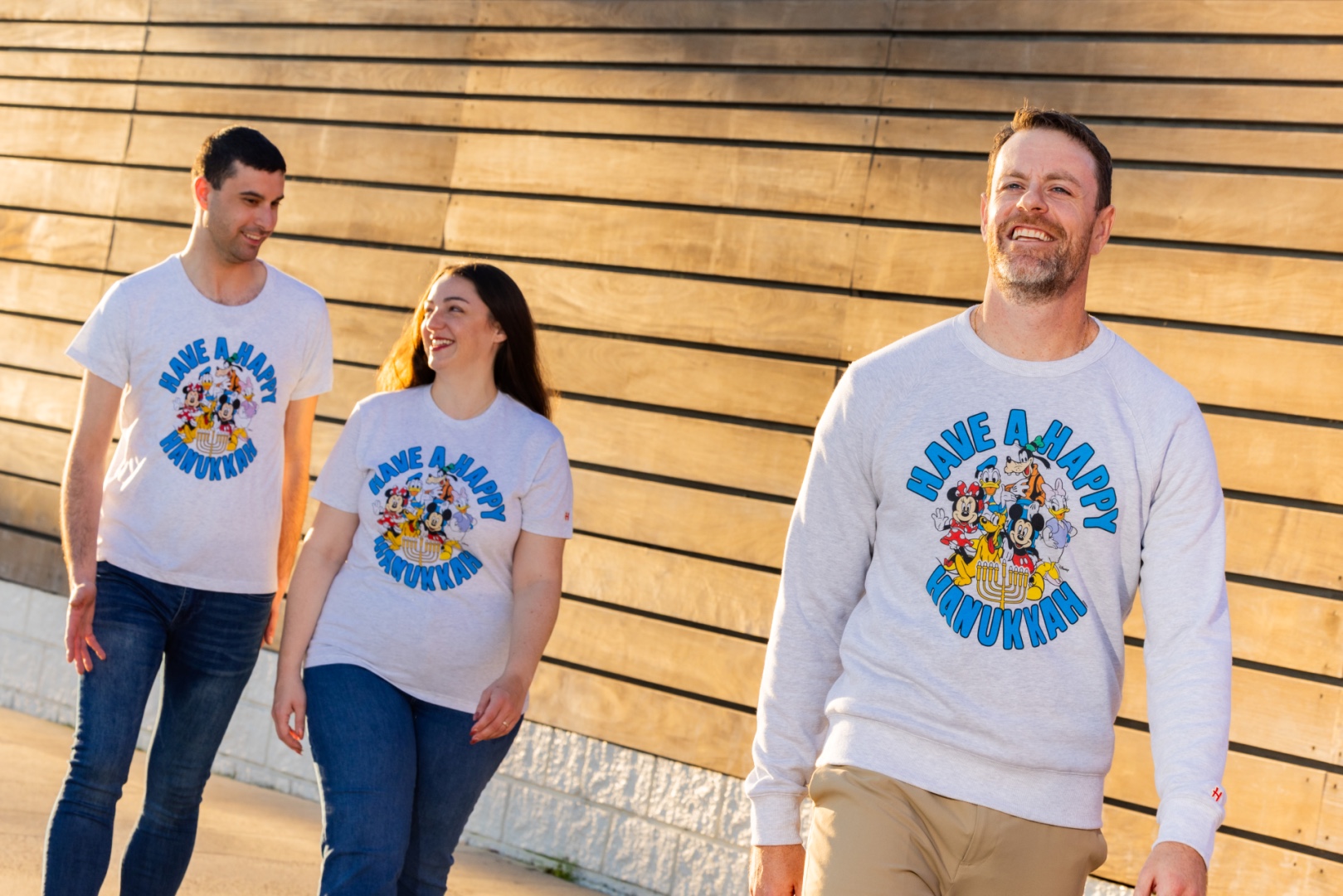 Models wearing the Homage Mickey and Friends Hanukkah apparel design