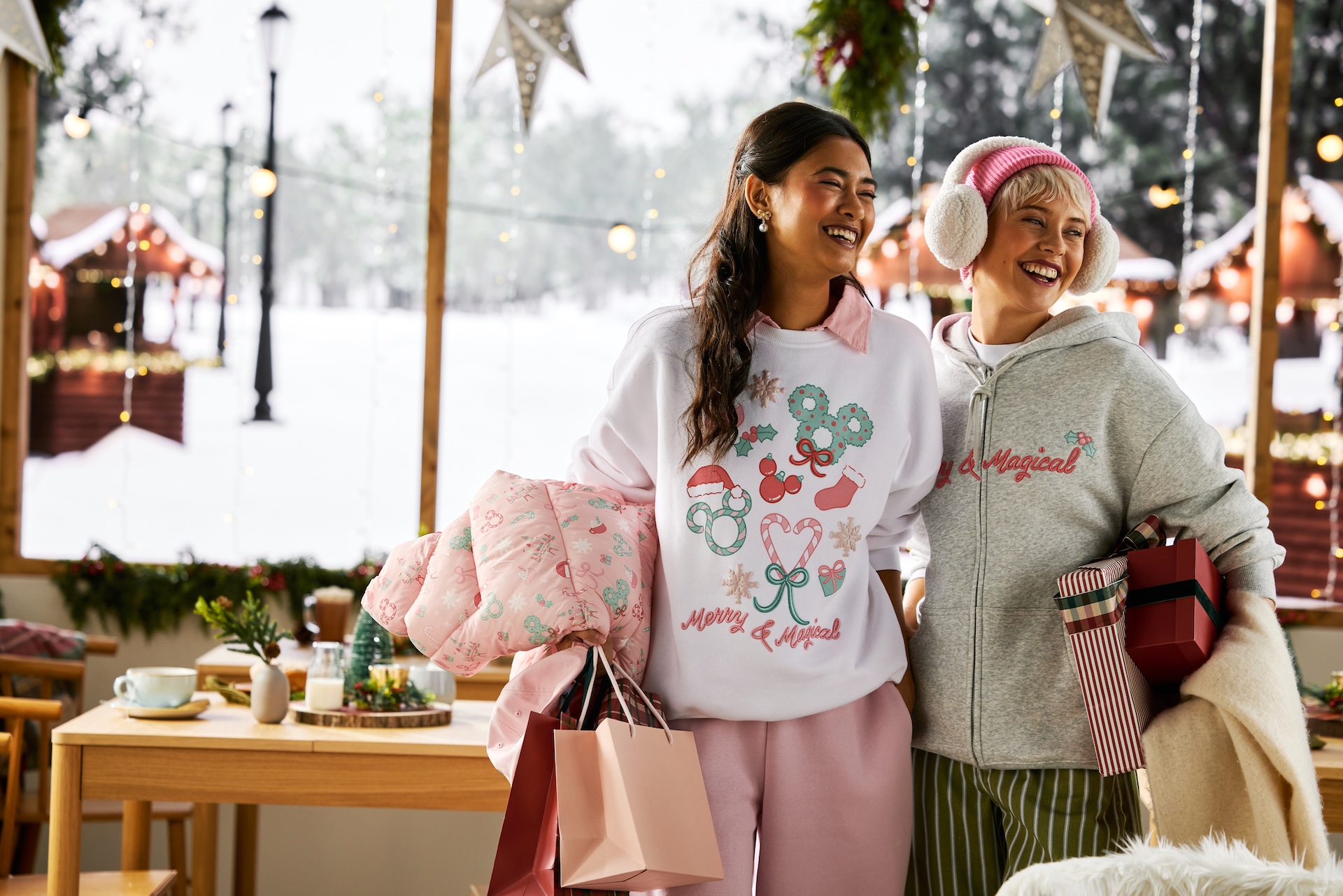 Two models wearing Disney Holiday Pastel apparel in pink, mint and white