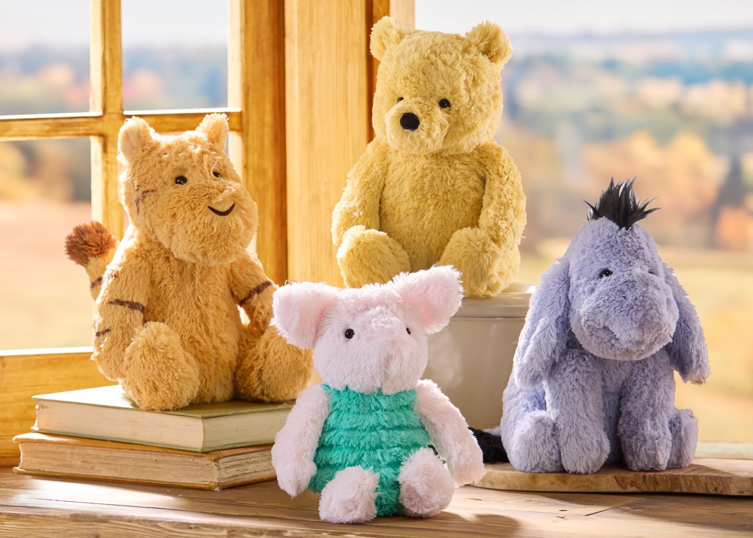 Winnie the Pooh, Tigger, Piglet and Eeyore Classic plush arranged by a sunny window