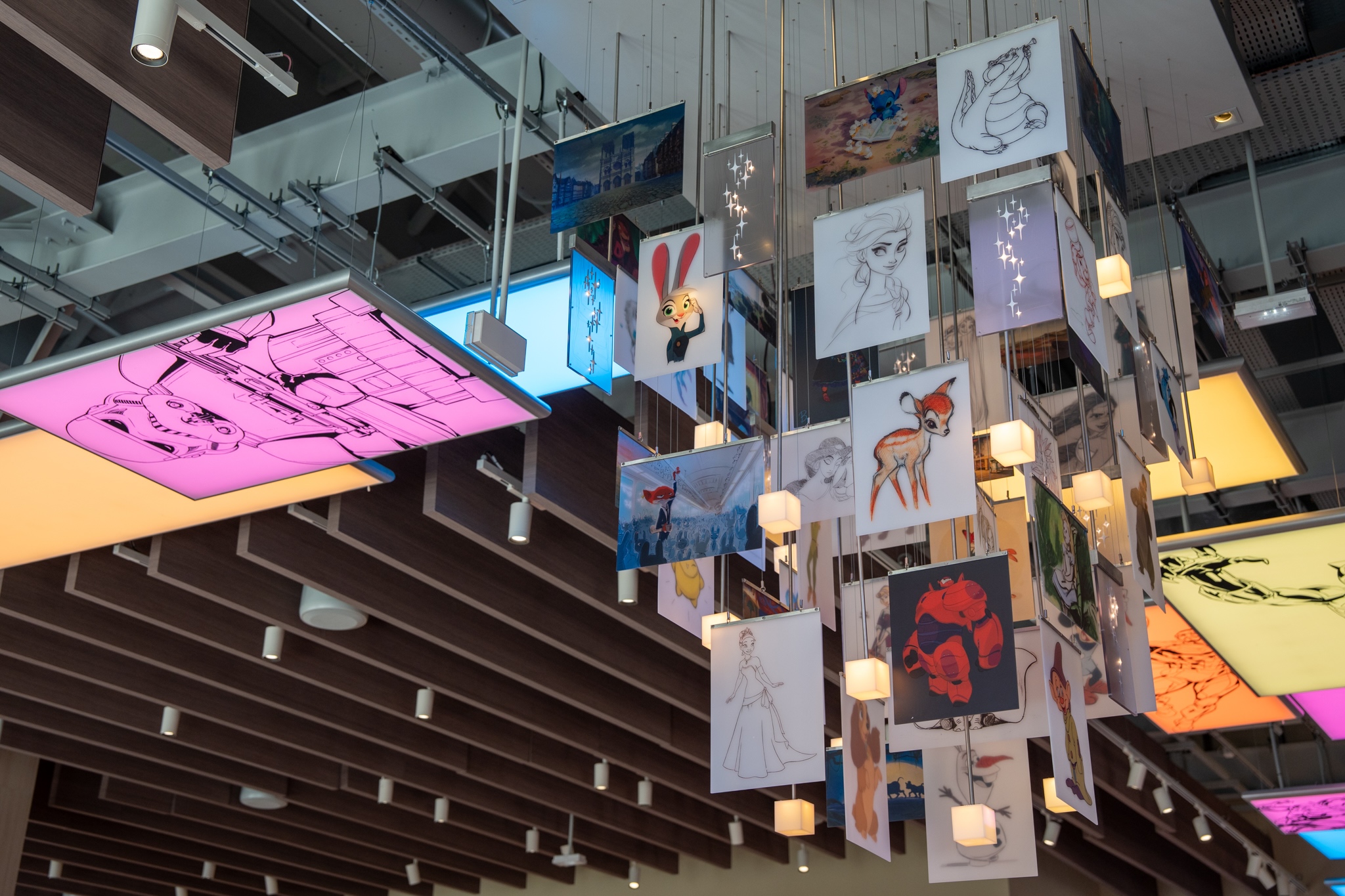Disney character illustrations suspended from a chandelier inside Disney Wonders