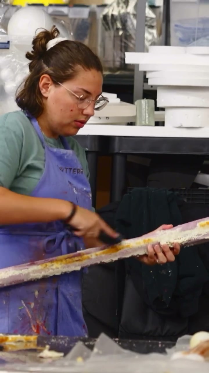 A Cedar Point props crew member works on a long foam piece inside the park’s workshop