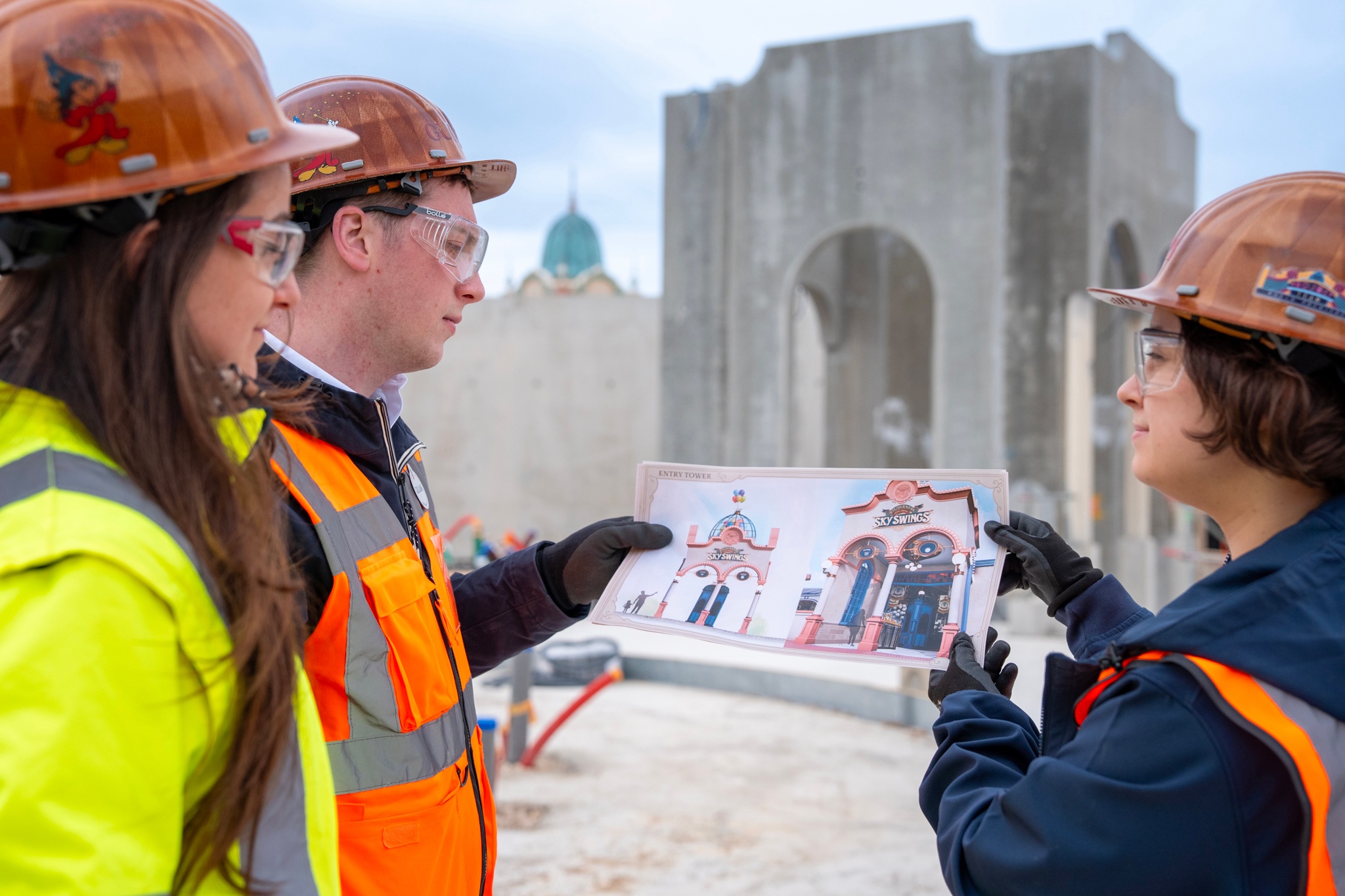 Disney Imagineers reviewing Wilderness Explorers Sky Swings concept art at the construction site