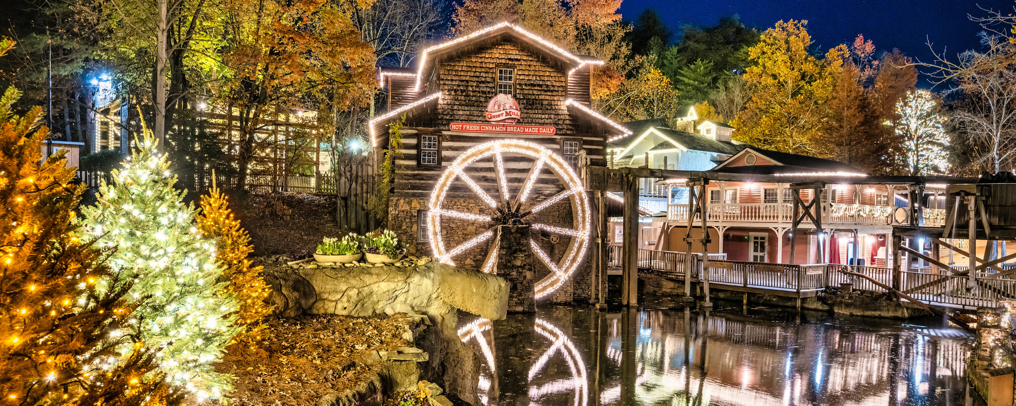 Dollywood’s Grist Mill and trees illuminated for Smoky Mountain Christmas