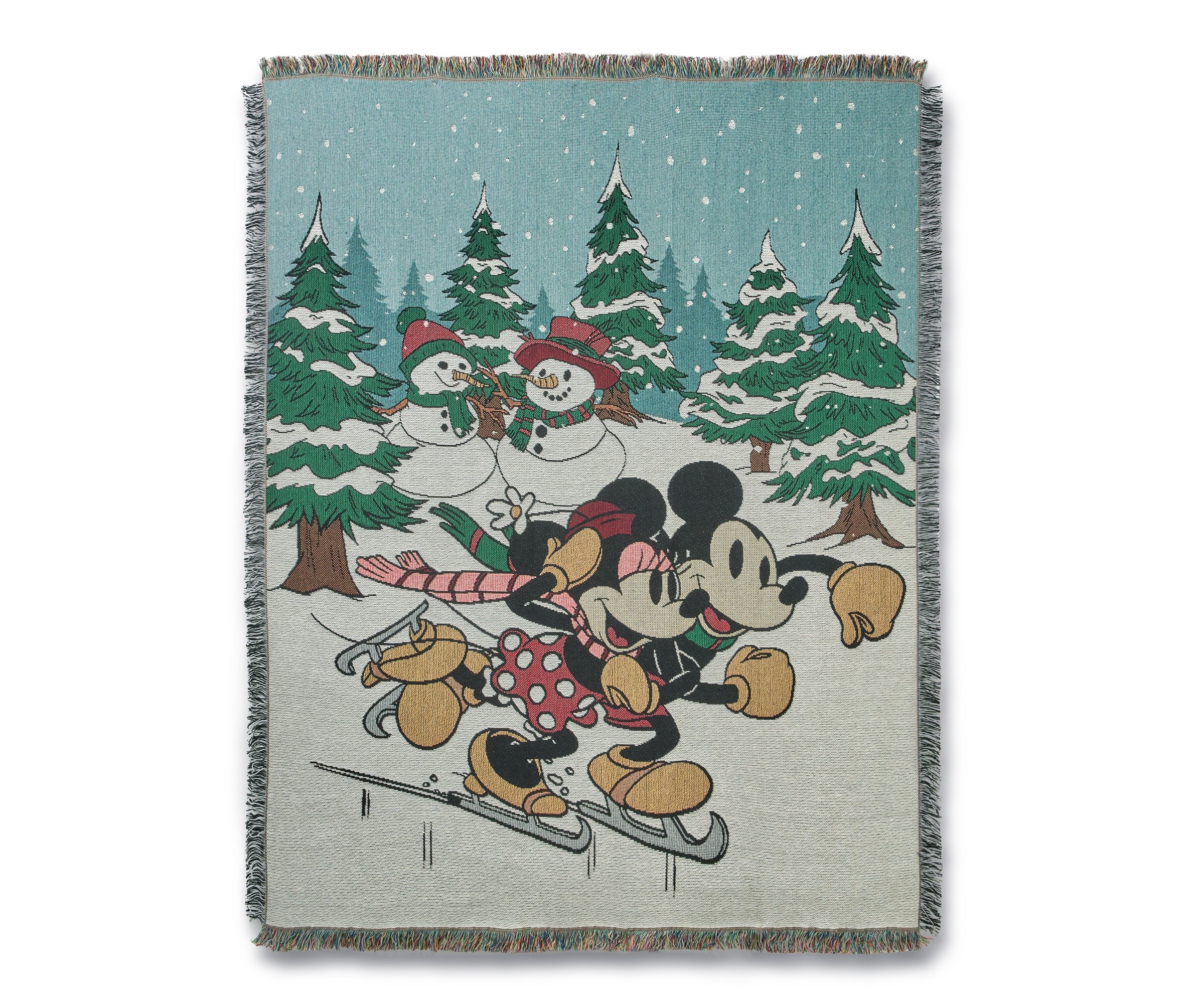 Mickey and Minnie skating on a fringed holiday throw blanket
