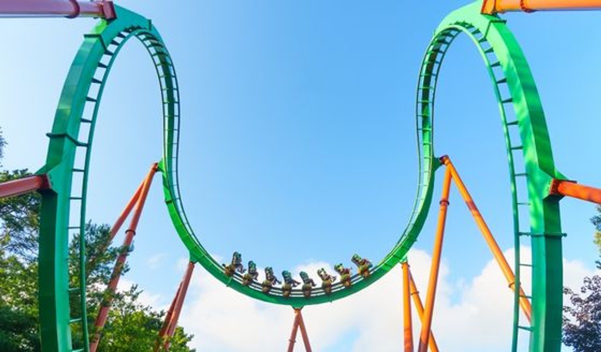 A Medusa train travels through a green inversion at Six Flags Great Adventure