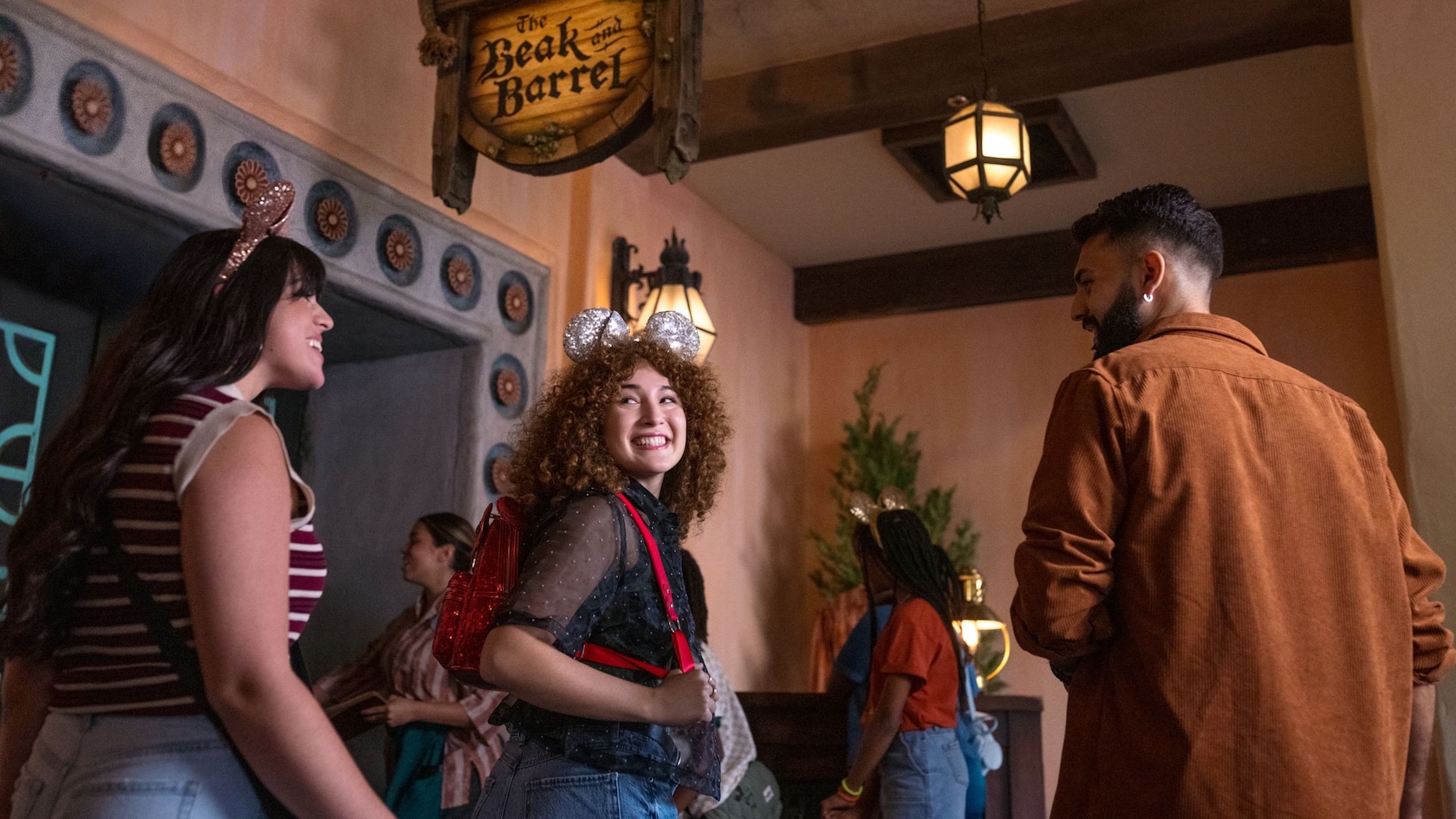 Guests entering The Beak and Barrel beneath its wooden sign