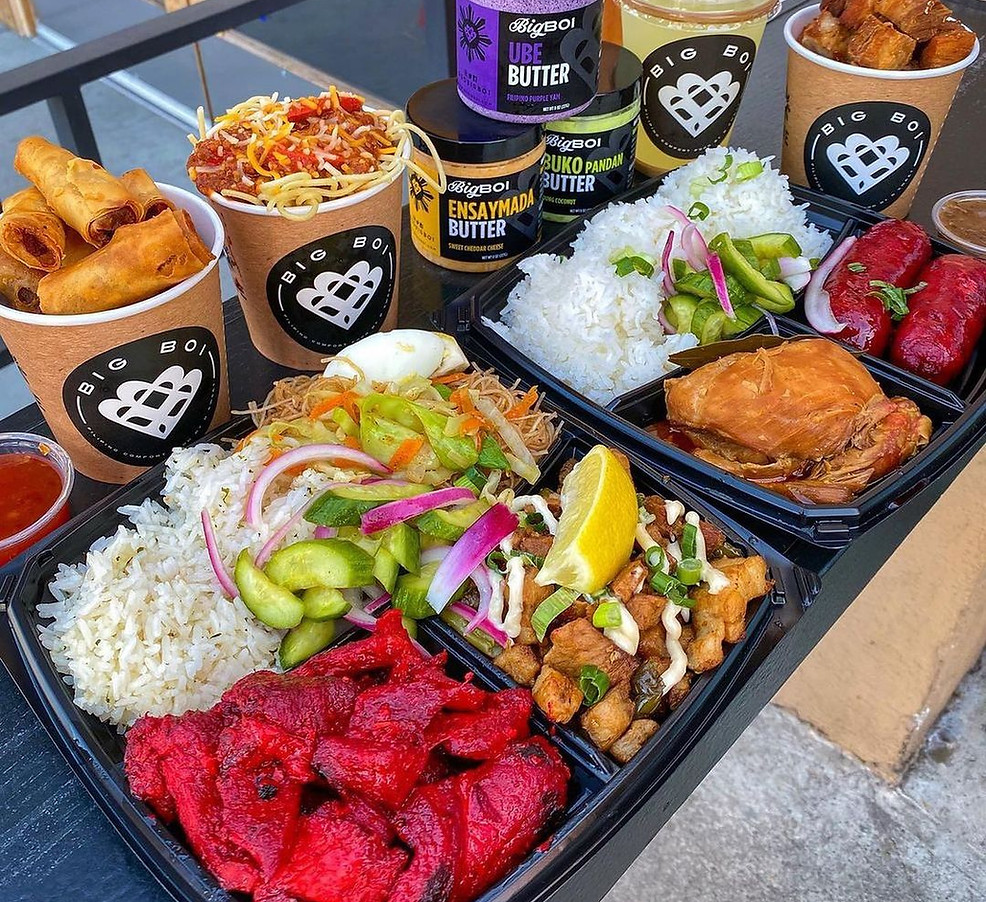 Big Boi Filipino food spread with branded lumpia cups, rice plates, sauces, and ube butter jars