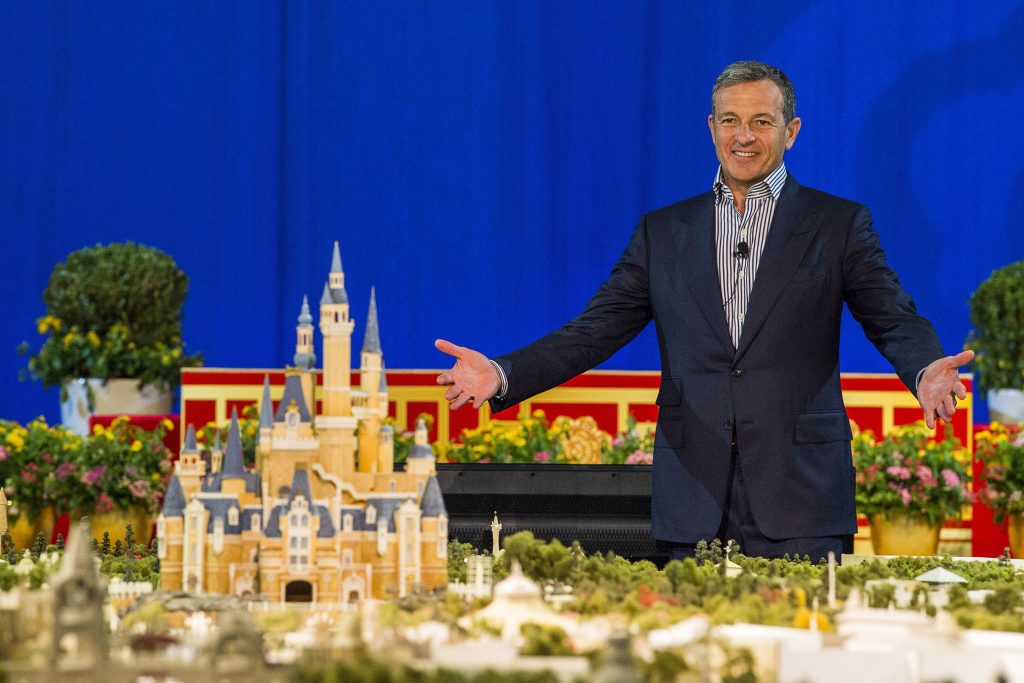 Bob Iger stands beside a model of Shanghai Disneyland