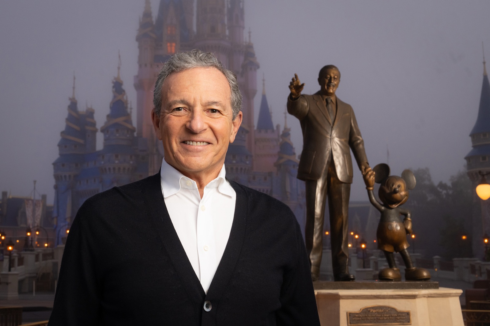 Bob Iger at Walt Disney World with the Partners statue and Cinderella Castle behind him