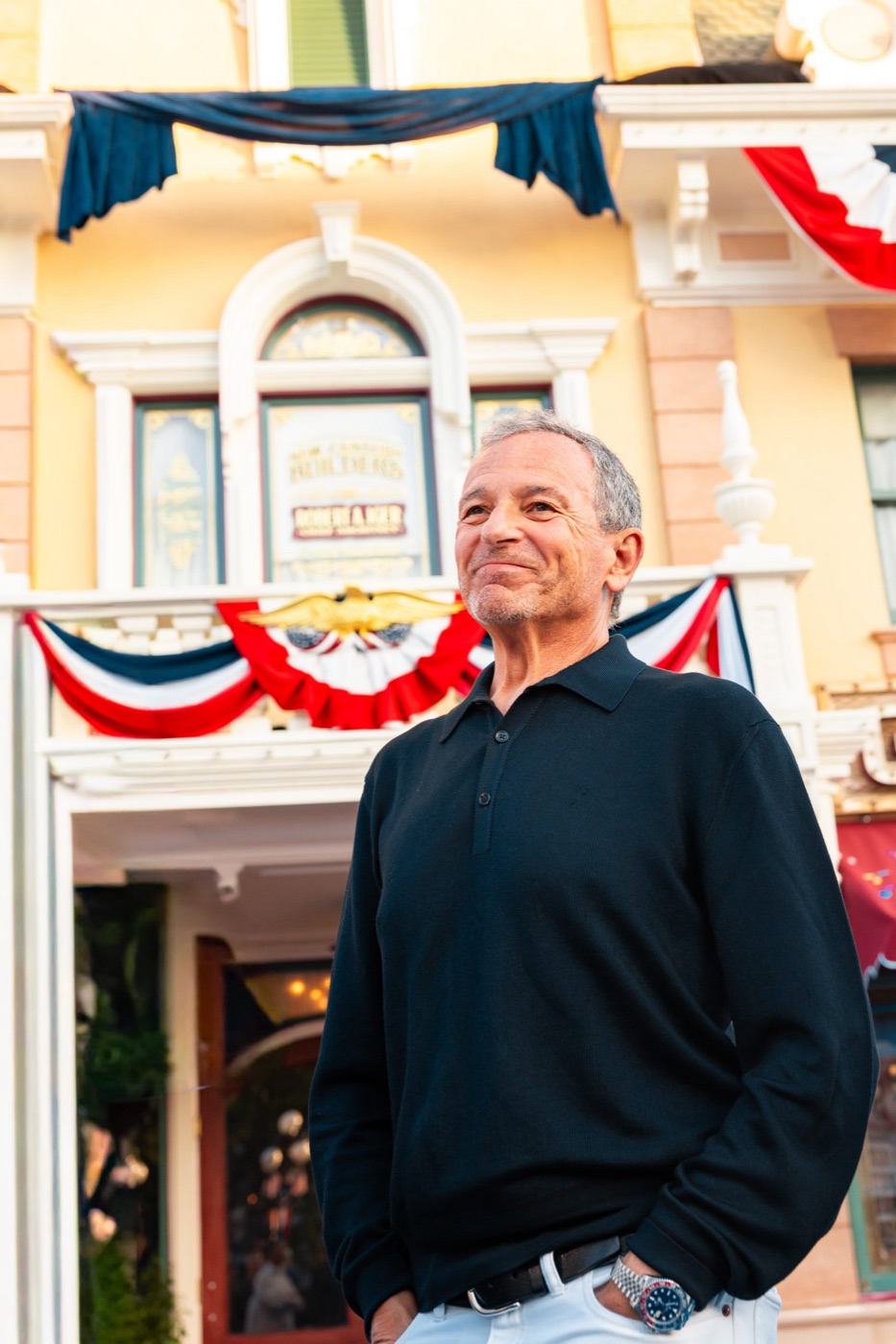 Bob Iger and Josh D'Amaro look up at the Disneyland tribute window