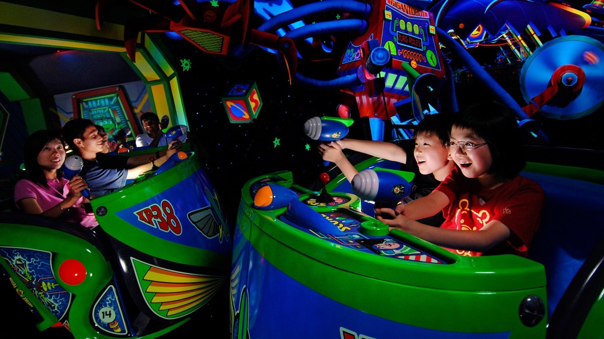 Families ride Buzz Lightyear Astro Blasters at Disneyland Park