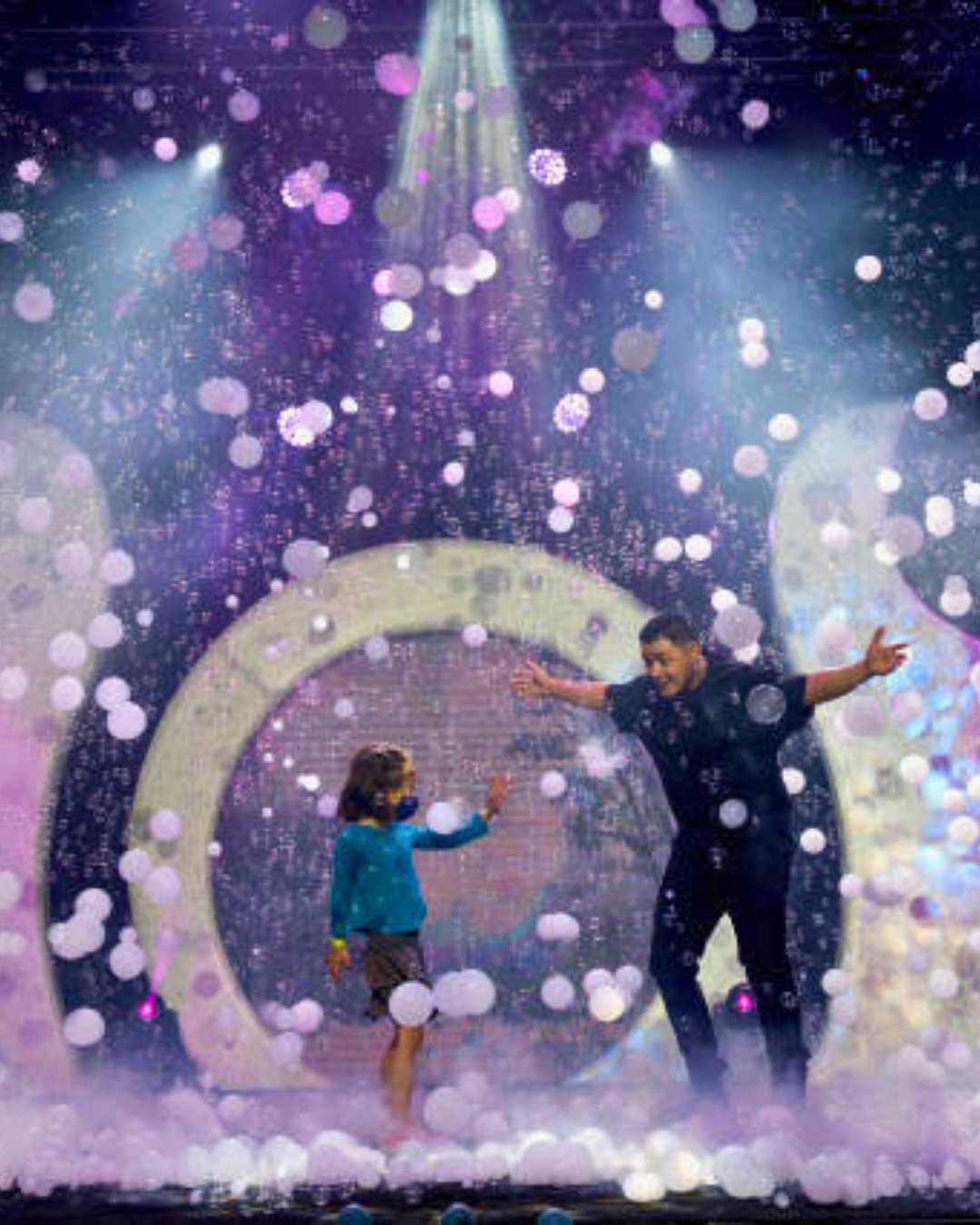 Audience volunteer inside a large bubble during Gazillion Bubble Show