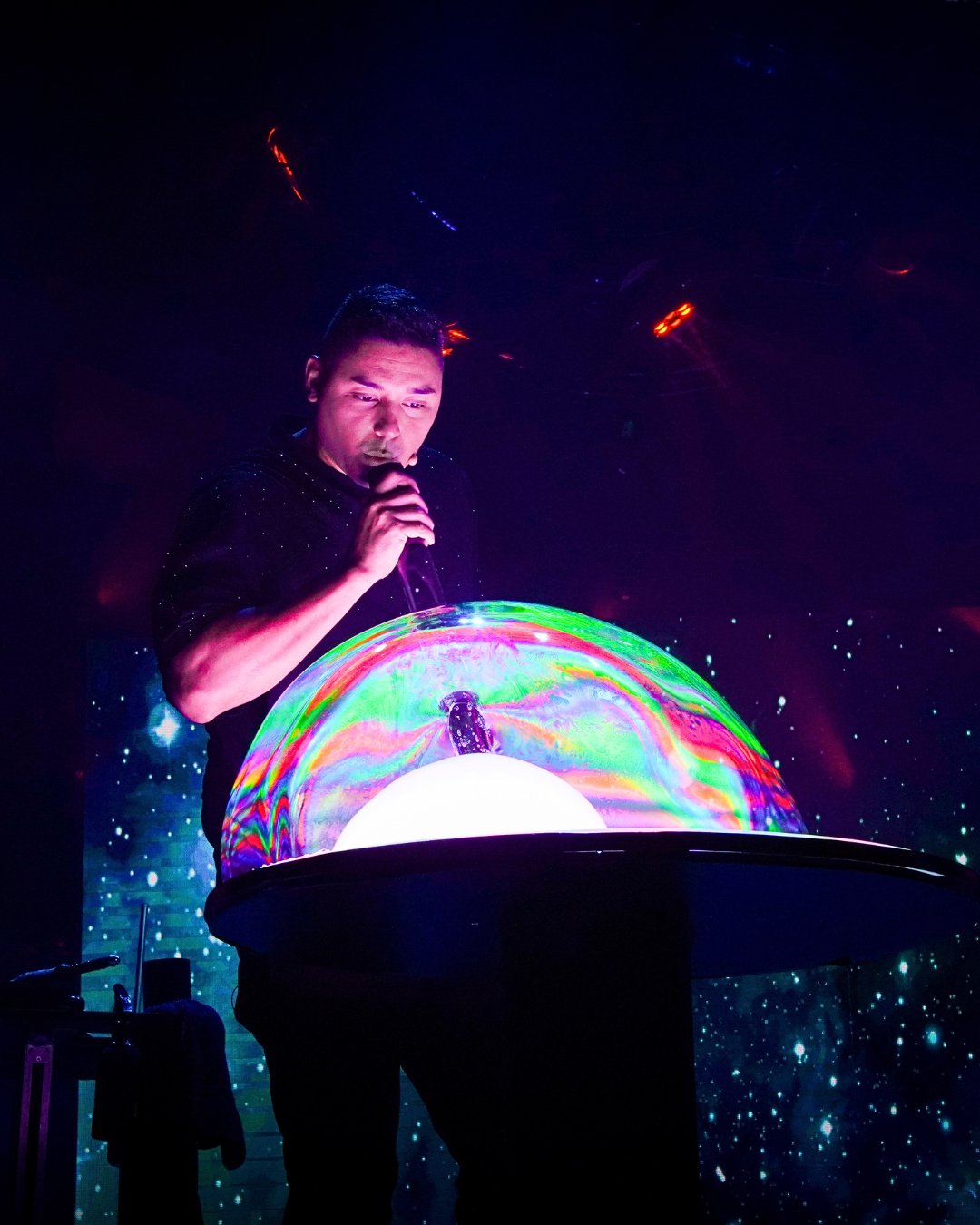Gazillion Bubble Show performer standing among bubbles at Carowinds Theater