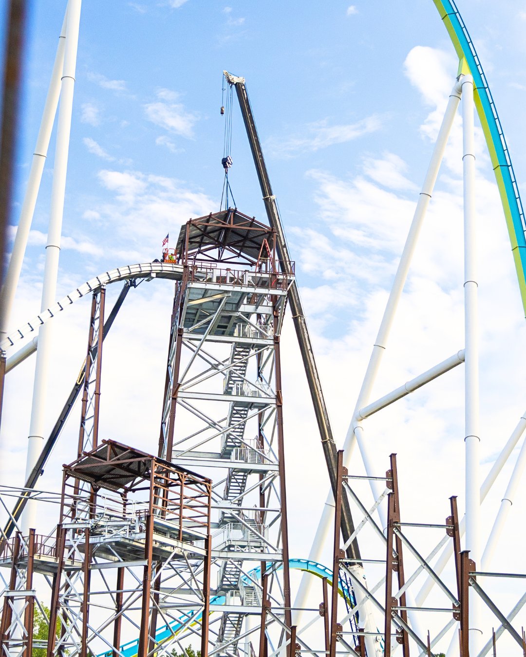 A crane installs the roof structure at the top of the Rip Roarin' Falls drop