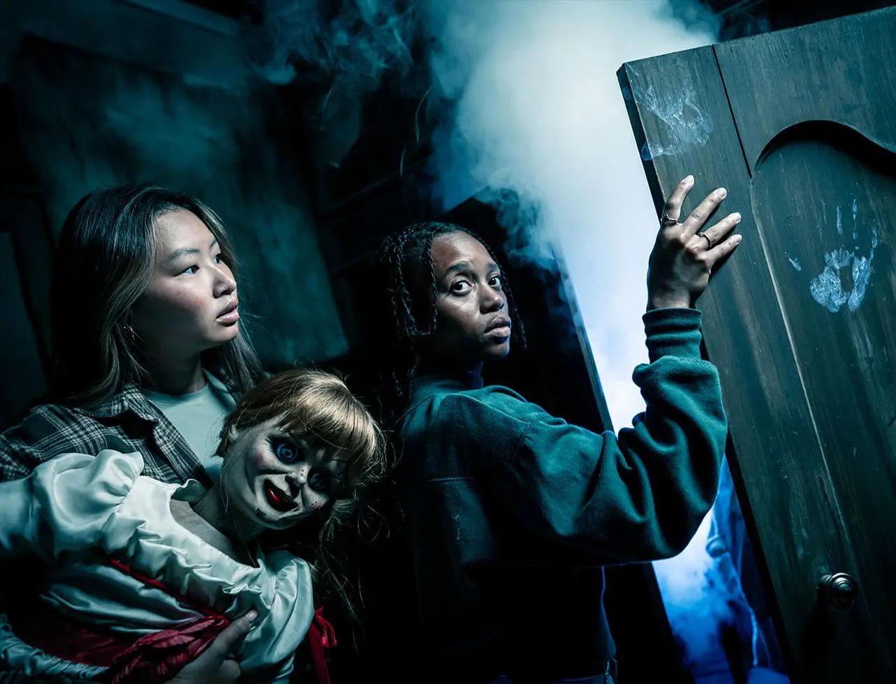 Guests facing Annabelle in The Conjuring: Beyond Fear SCarowinds artwork