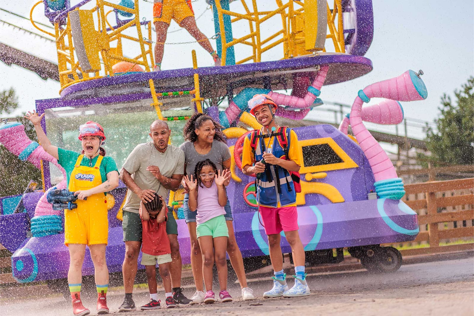 Performers spray water beside guests during SPLASH! Water Parade at Carowinds