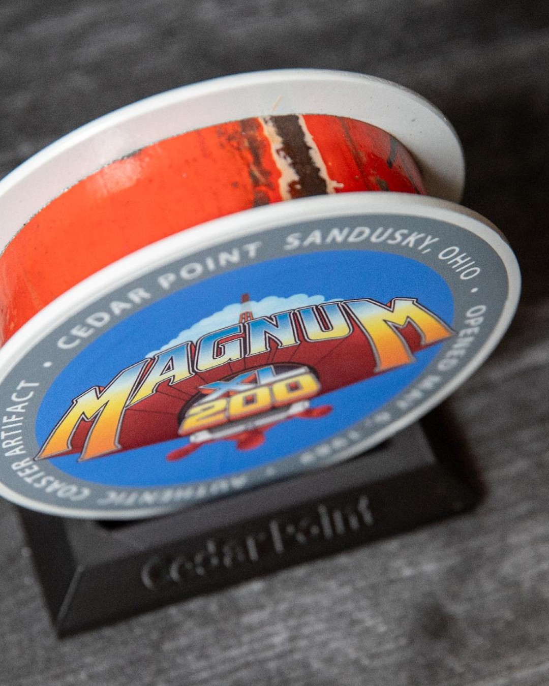 Close view of a Magnum XL-200 track slice with red paint visible between two white outer faces