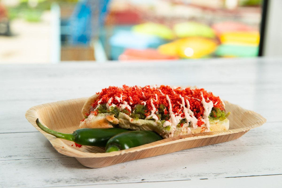 A Firecracker Dog topped with jalapeno relish, sriracha mayo, and Flamin' Hot Cheetos