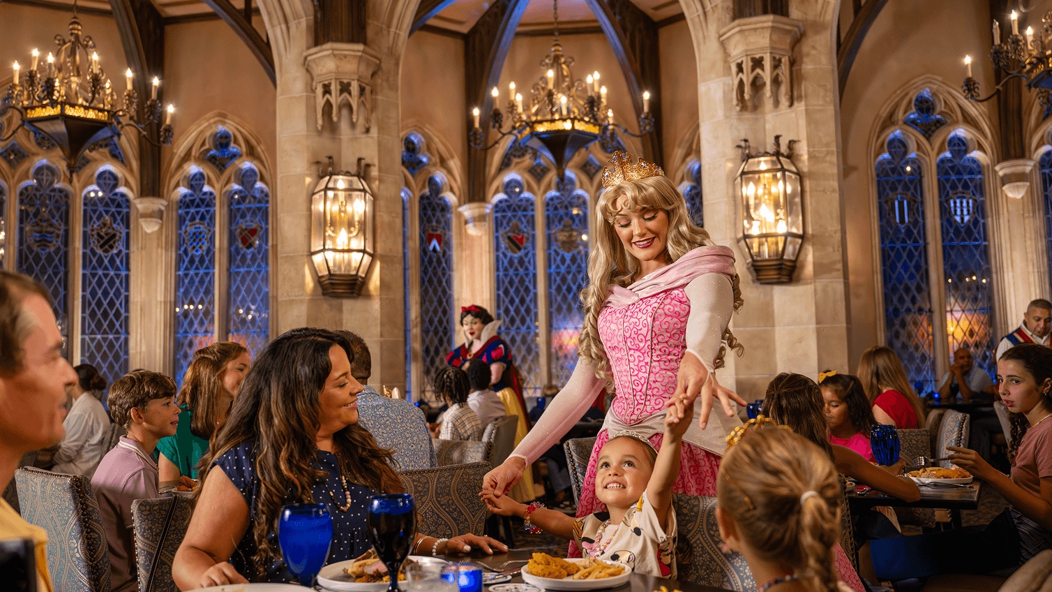 Princess Aurora greets a child at Cinderella's Royal Table