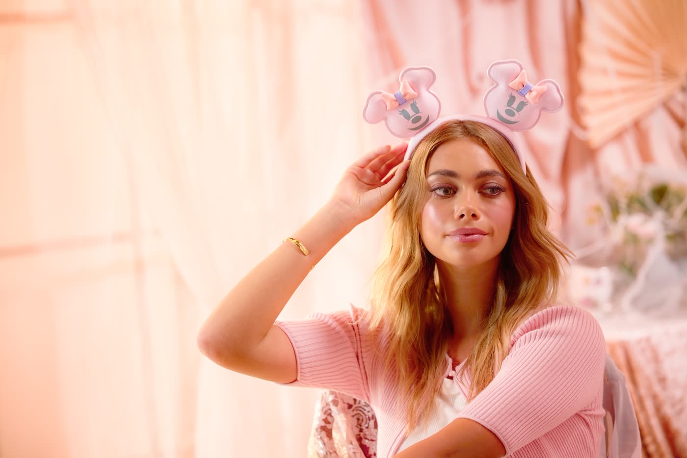 Model wearing a pink Minnie Mouse pumpkin ear headband