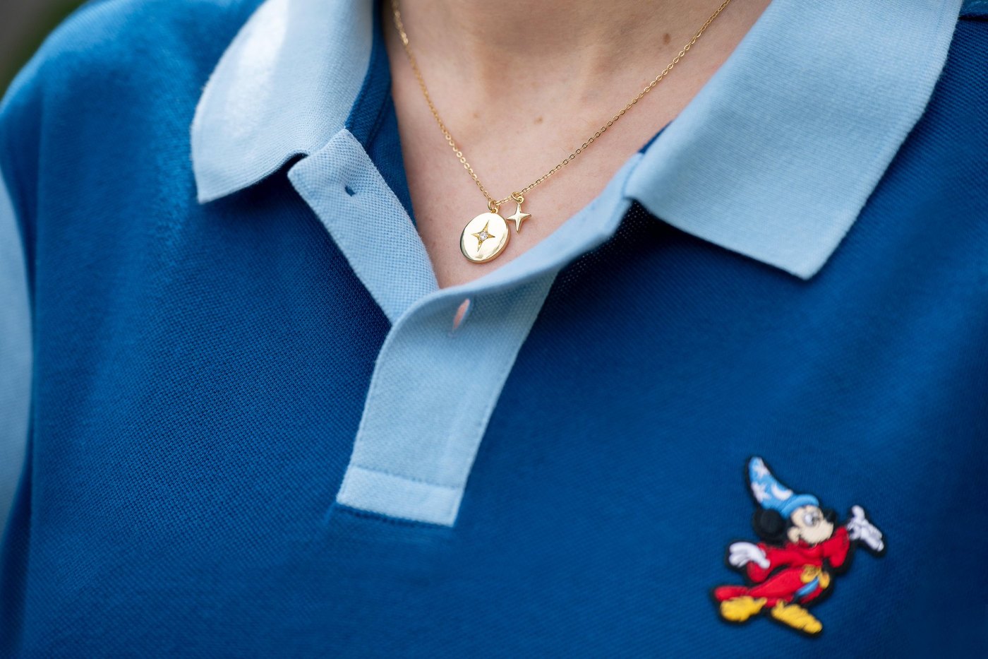 Blue polo with Sorcerer Mickey patch and gold pendant necklace