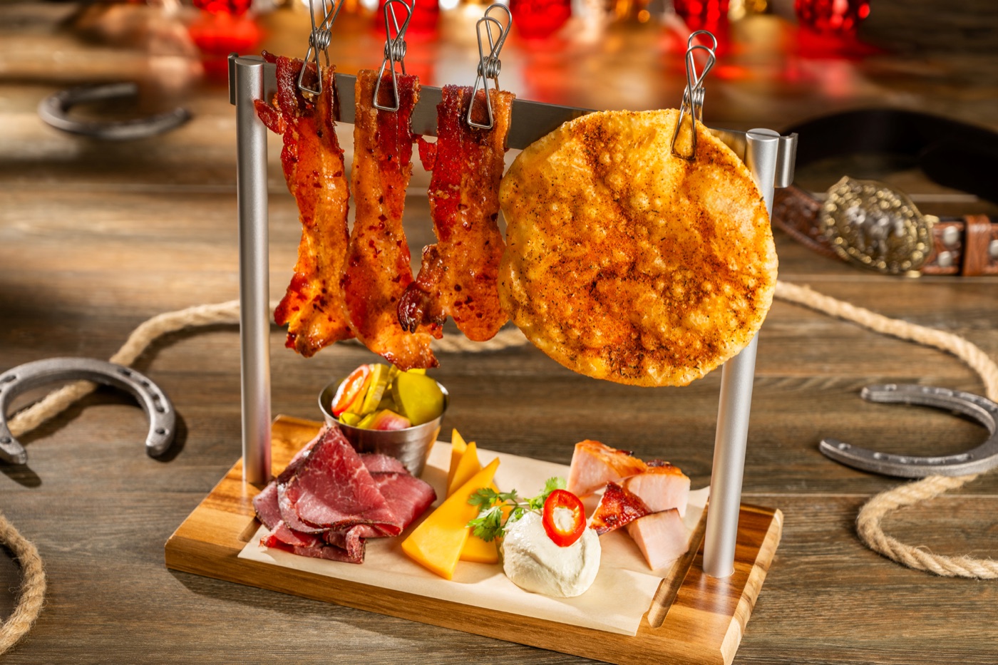 Charcuterie board with cured beef, bacon, smoked pork, cheeses and pickles