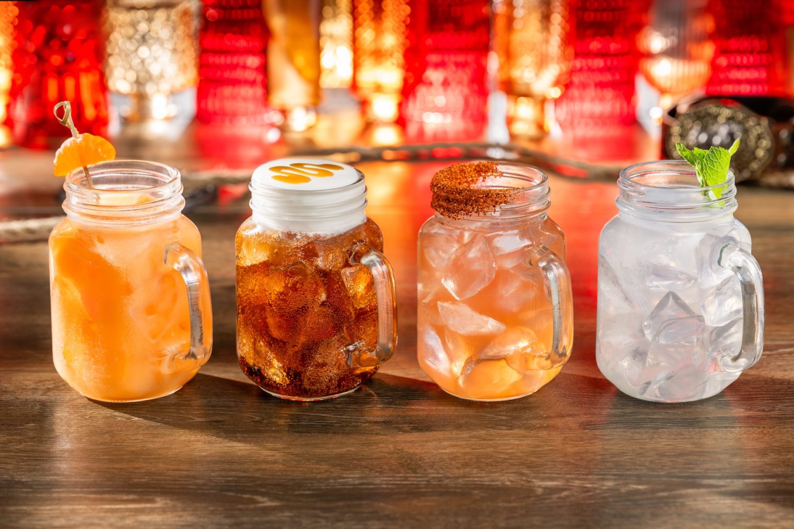 Four colorful specialty drinks served in mason jars at The Diamond Horseshoe